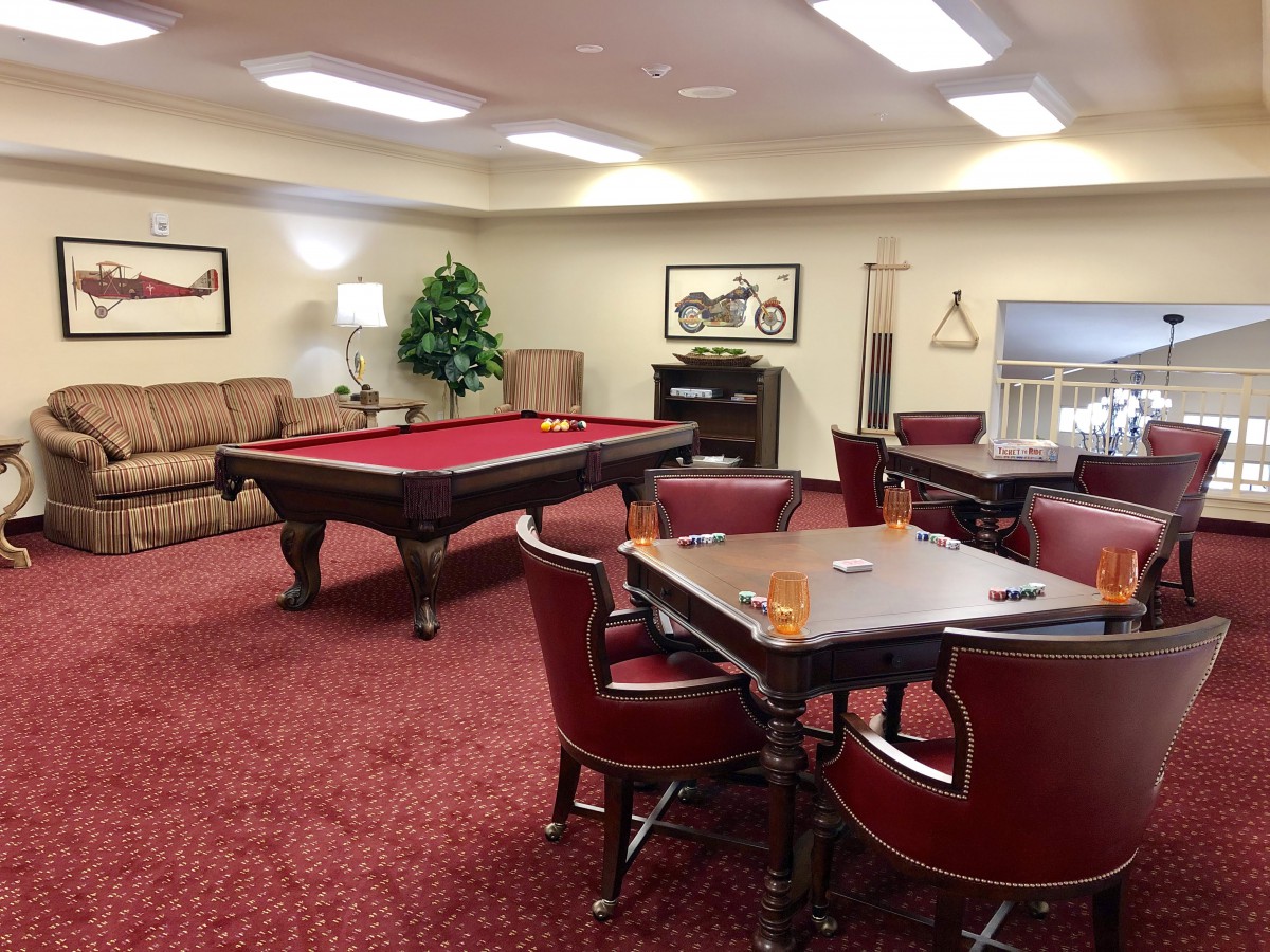 A cozy game room featuring a pool table and seating area.