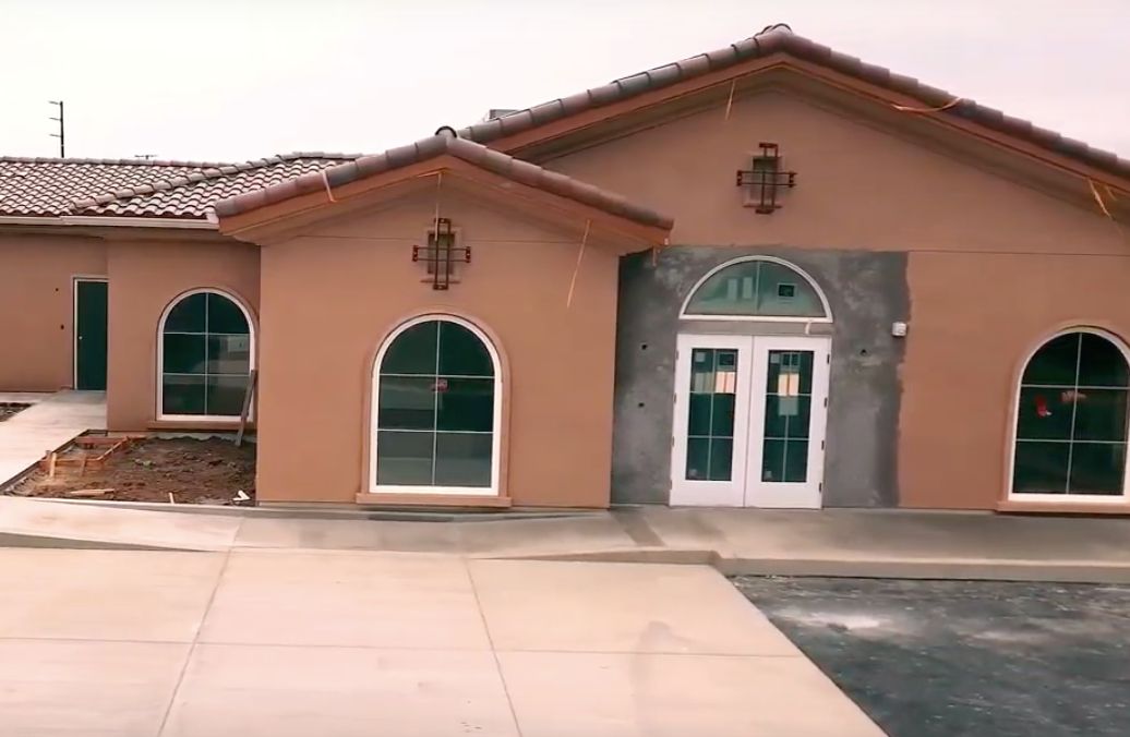 A single-story building with arched windows and a tiled roof.