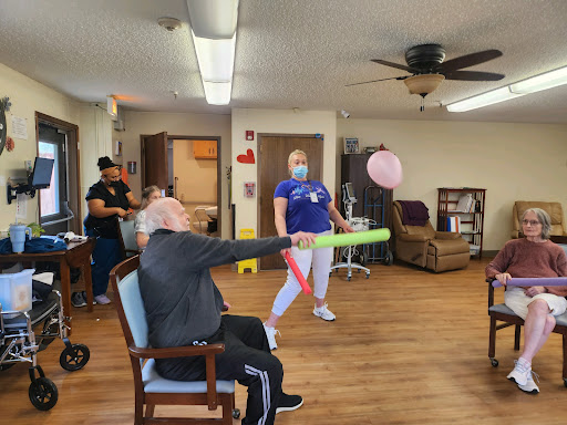 Residents and staff engage in a fun activity, promoting movement and social interaction.