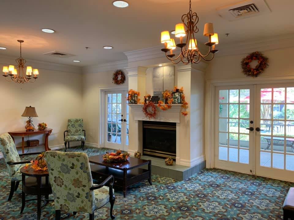 A cozy living room with a fireplace and fall-themed decorations.