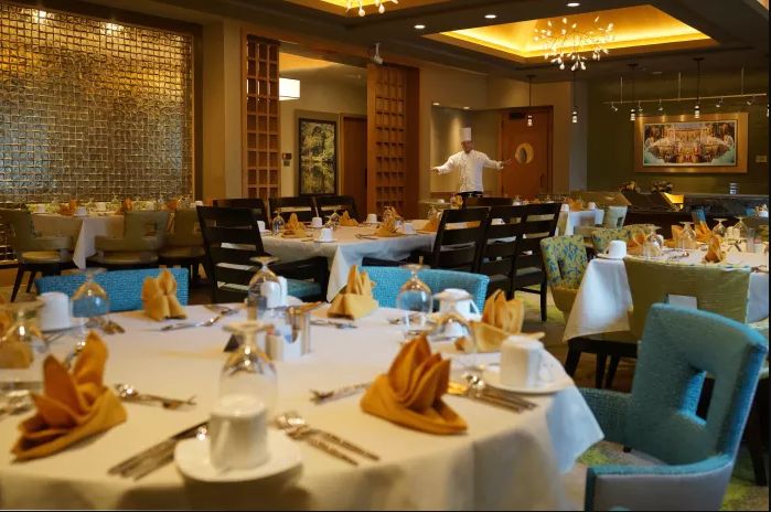 A well-prepared dining area with elegantly set tables in a restaurant.