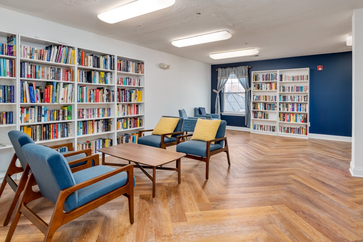 A modern library with comfortable seating and well-organized bookshelves.