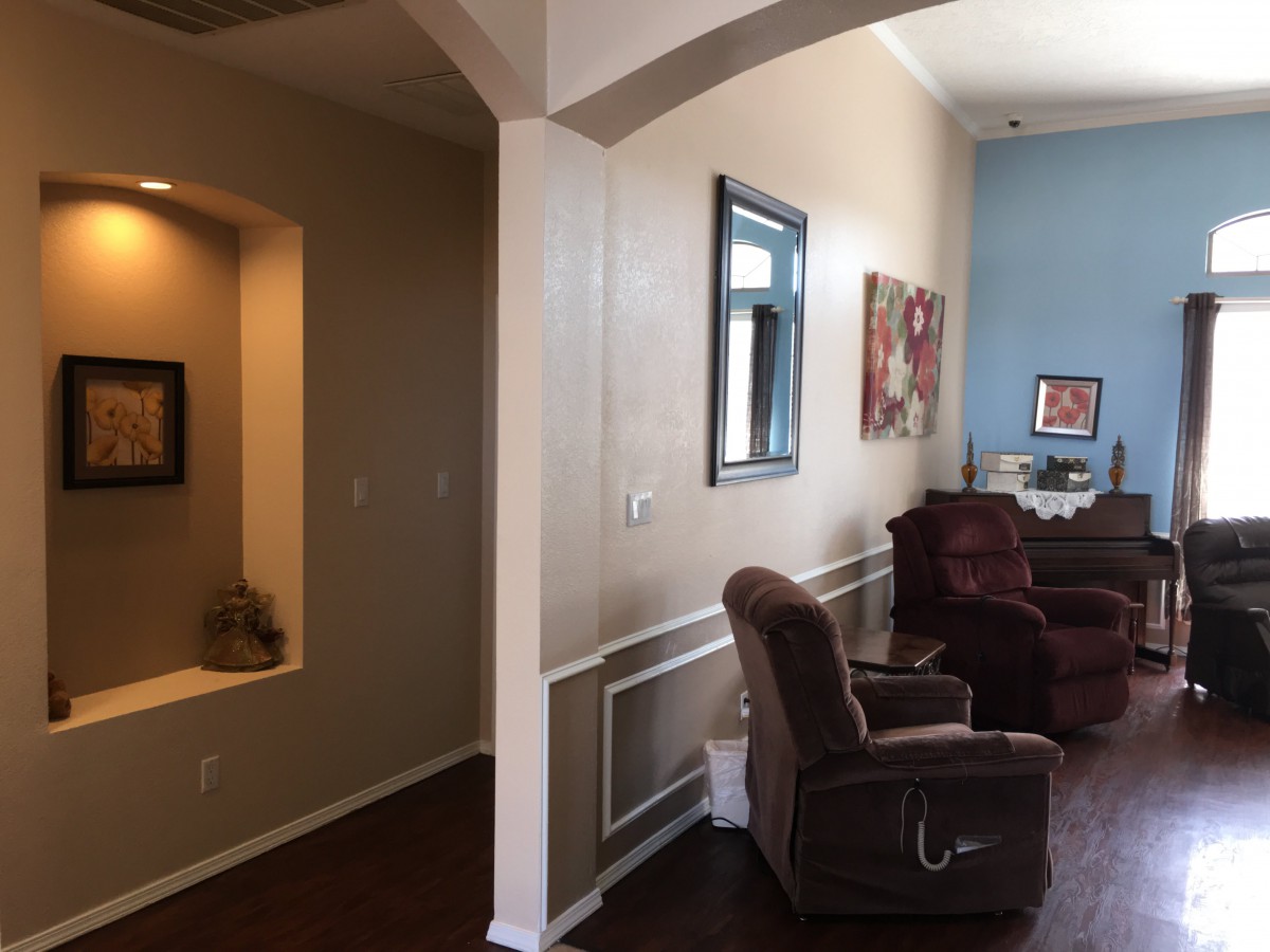 A cozy living room featuring recliner chairs and wall art.
