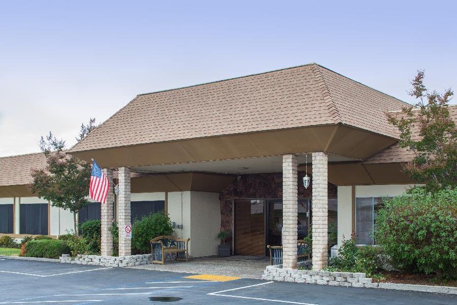 The entrance of a building with columns and an American flag displayed.