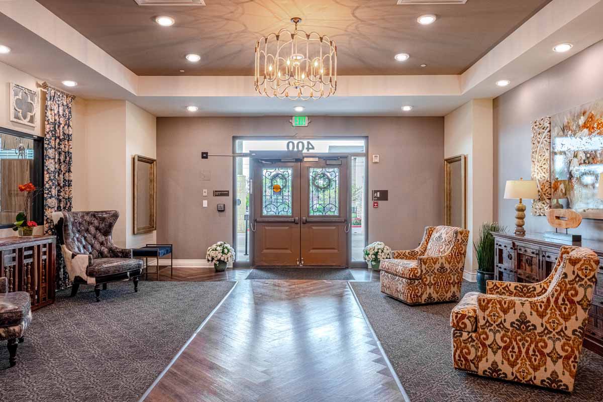 A well-appointed lobby with a chandelier, comfortable seating, and an inviting entrance.