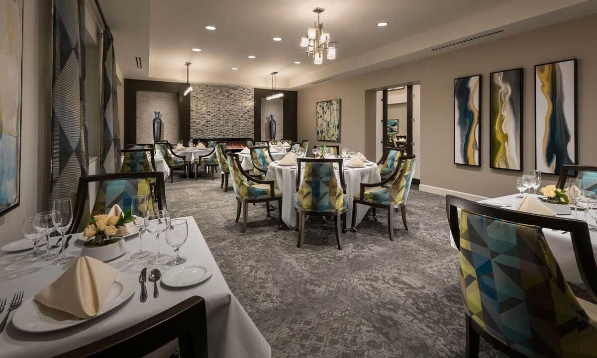 A beautifully decorated dining area with elegantly set tables and chairs.