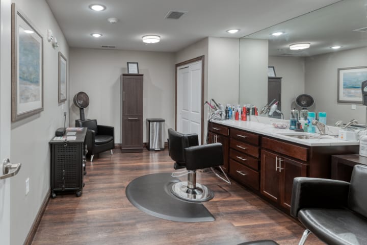 A modern hair salon interior with styling stations and comfortable chairs.
