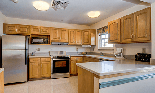 A traditional kitchen with wooden cabinets and modern appliances.