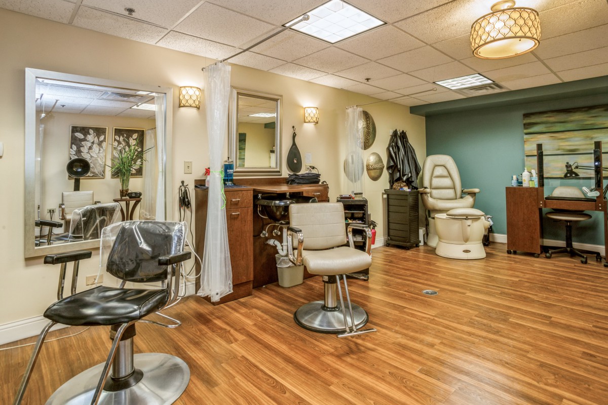 A well-equipped hair salon interior with chairs, mirrors, and modern decor.