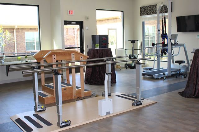 A well-equipped physical therapy and rehabilitation center featuring specialized exercise equipment.