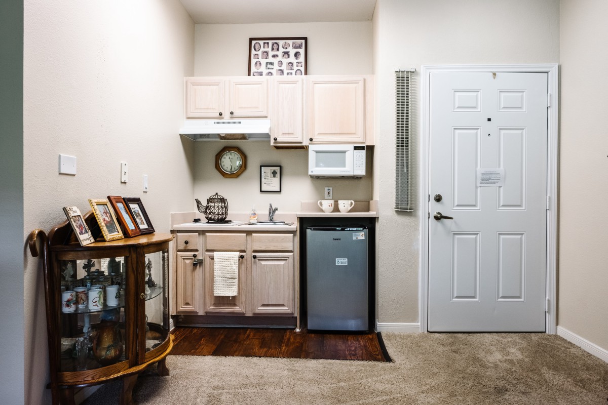 A compact kitchen with essential appliances and decor elements.