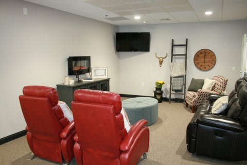 A cozy home theater setup with red recliners and modern decor.