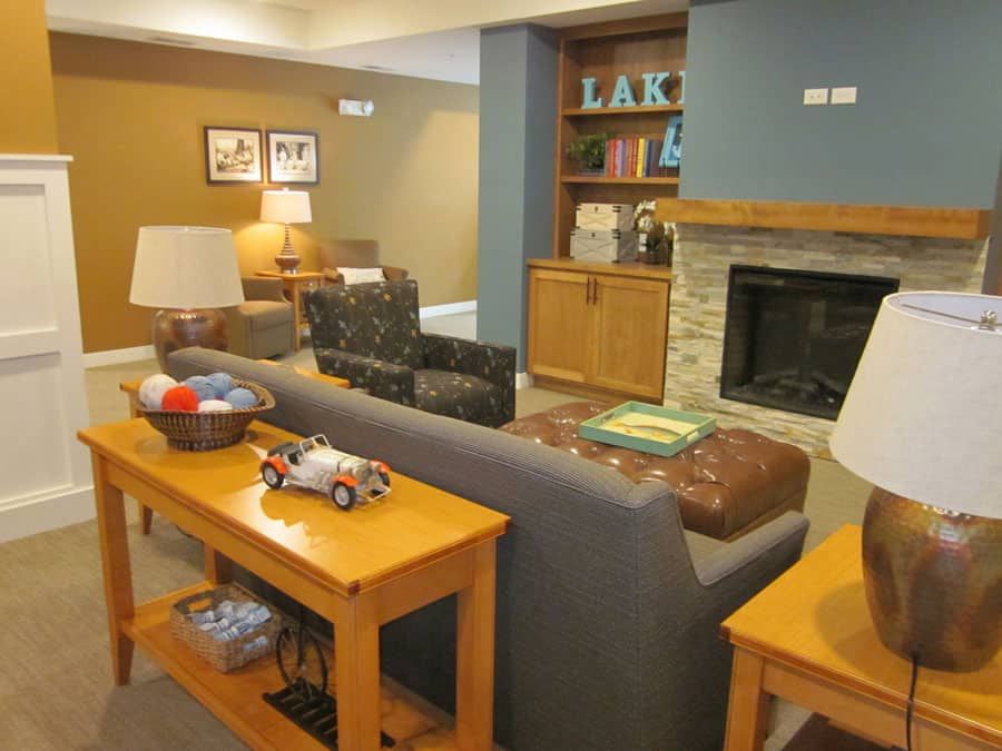 A cozy and well-decorated living room with a fireplace and comfortable seating.
