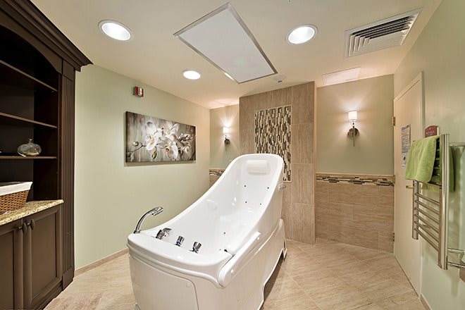 A luxurious spa room featuring a sleek bathtub designed for ultimate relaxation.