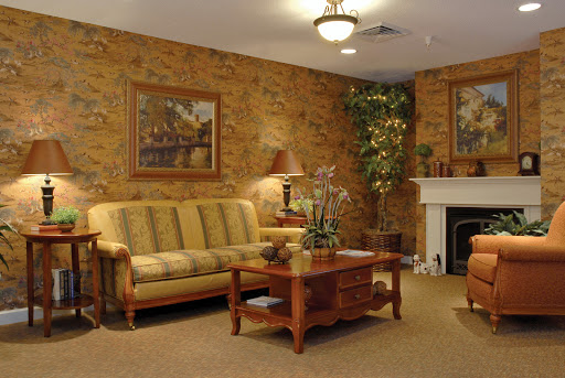 A cozy living room featuring a comfortable sofa, a wooden coffee table, and decorative artwork on the walls.