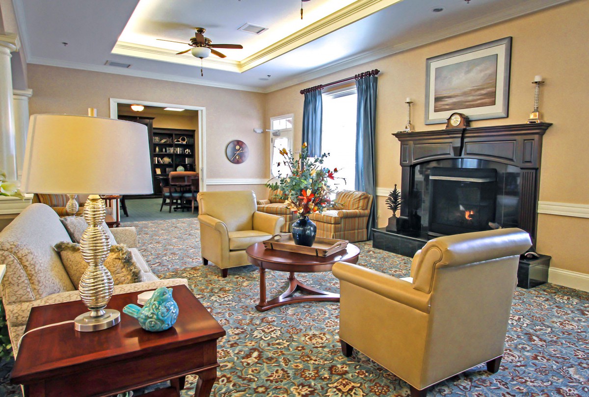A cozy living room with elegant decor, featuring a fireplace and comfortable seating.