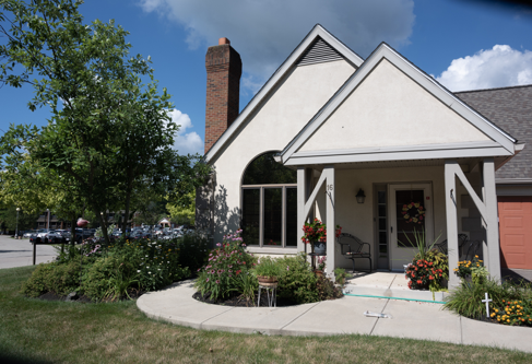 A charming residential house with a well-maintained garden and a welcoming entrance.