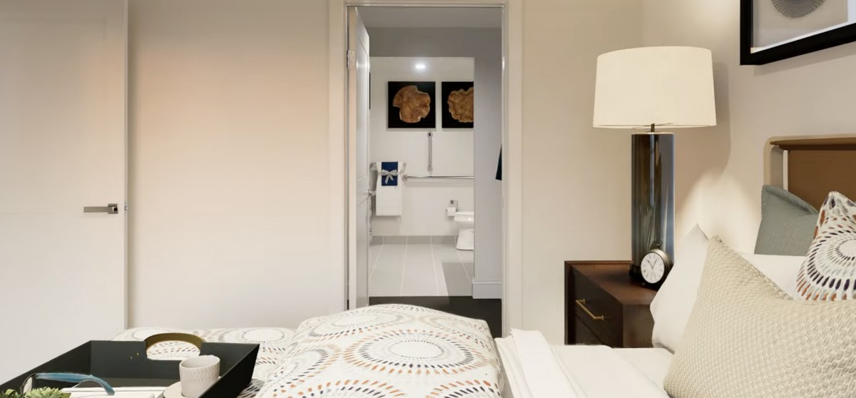 A modern bedroom with a view into an adjoining bathroom, featuring contemporary decor.