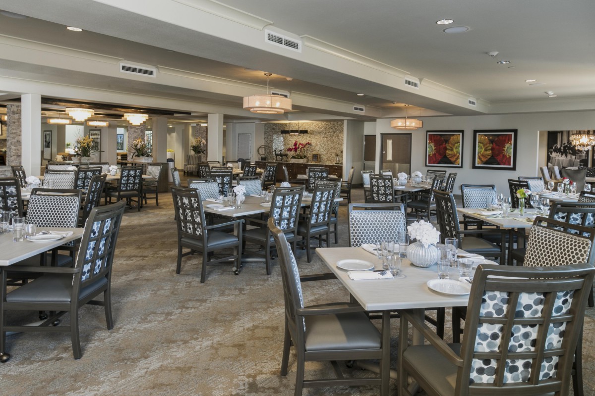 A modern restaurant dining area with well-arranged tables and comfortable chairs.