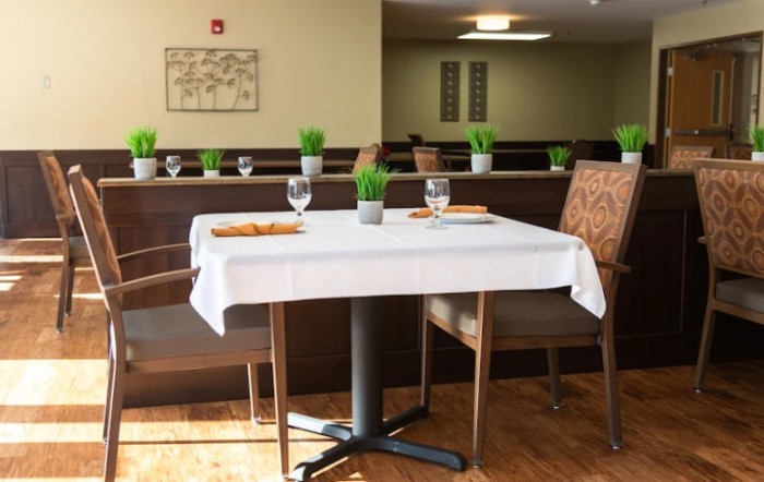 A neatly set dining table in a restaurant interior.