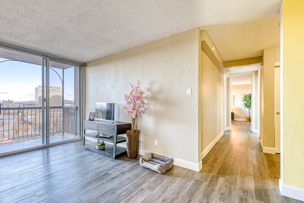 A bright living room with modern decor and natural light streaming through large windows.