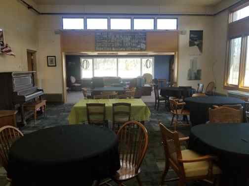 An indoor space set up with tables and chairs, possibly for meetings or events.