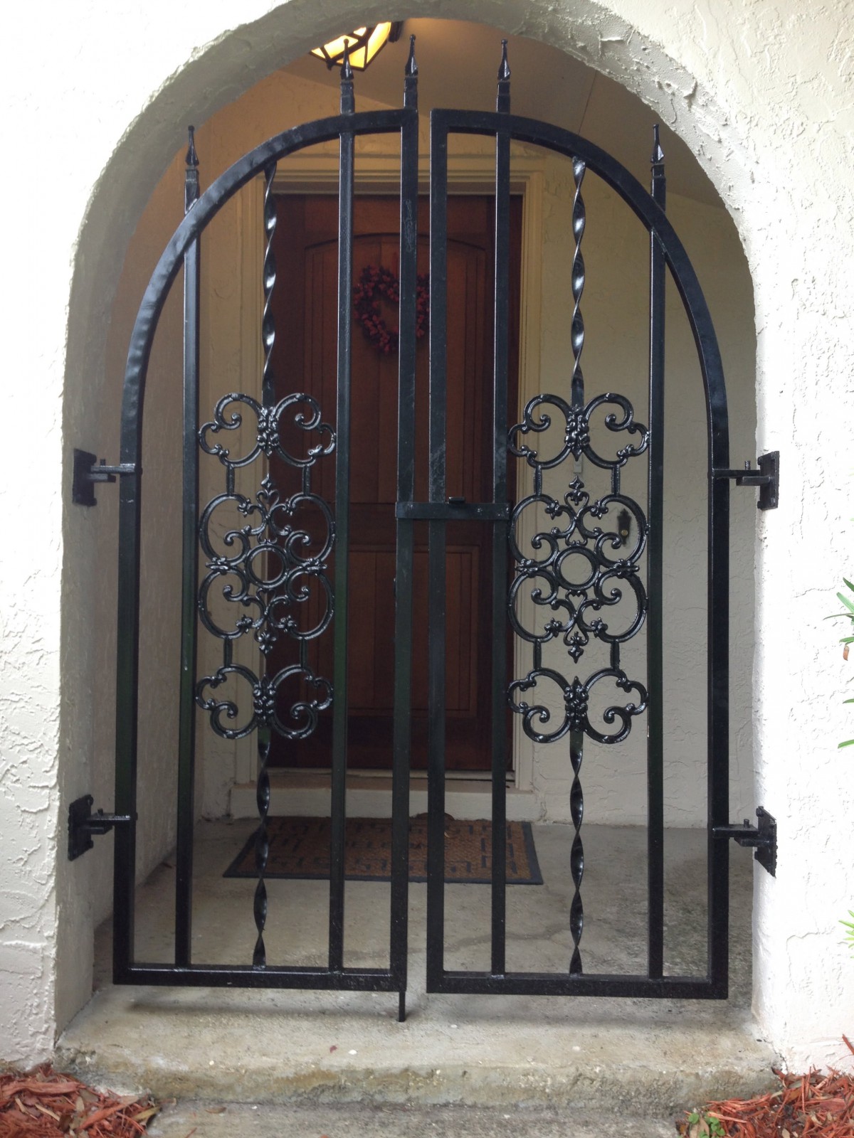 A decorative iron gate with intricate designs at an entrance.