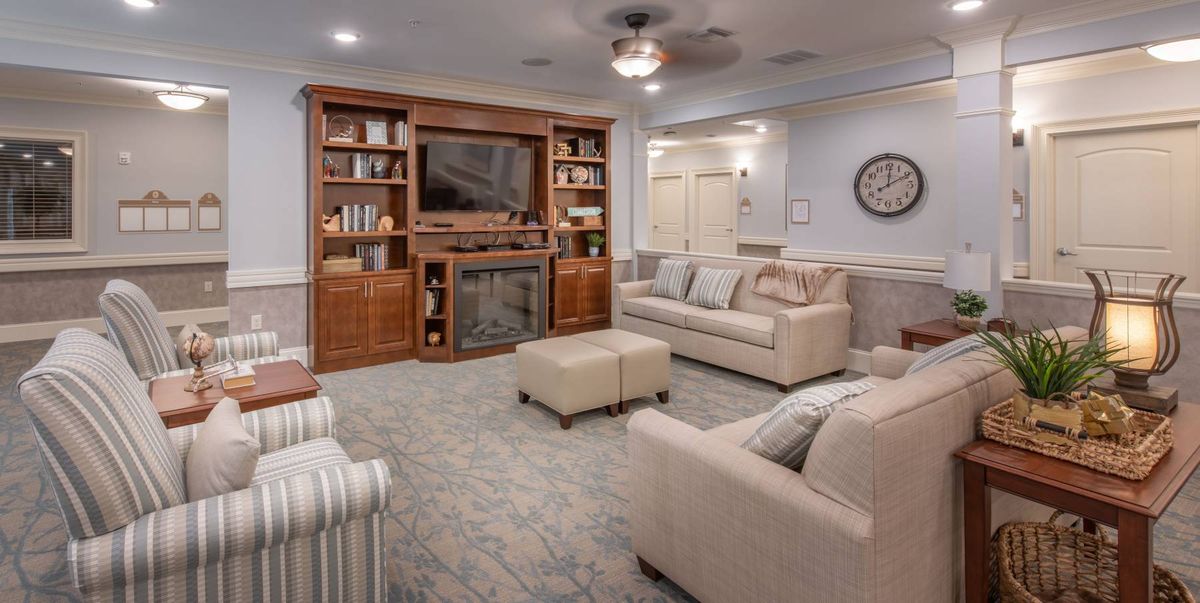 A cozy living room with comfortable seating and a large entertainment center.
