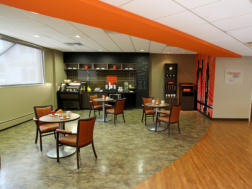 A modern waiting area featuring stylish chairs and a coffee station.