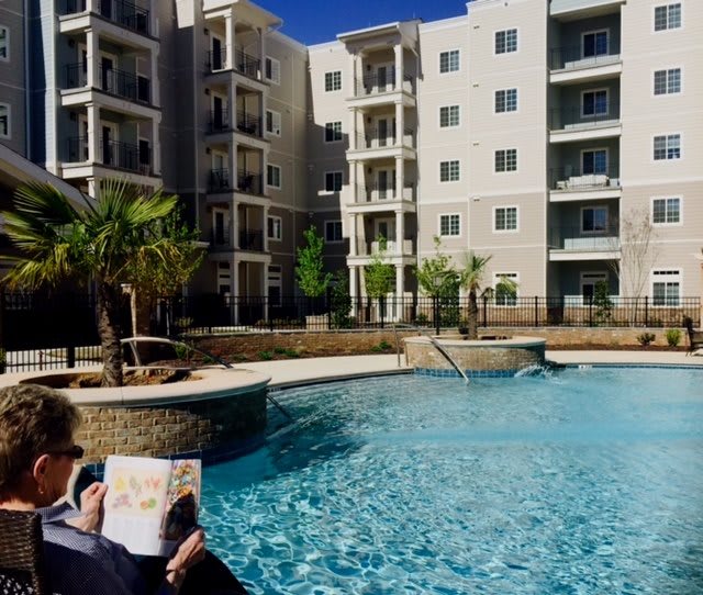 A relaxing day by the pool at a modern apartment complex.