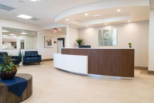 A modern reception area featuring a comfortable waiting space and contemporary decor.