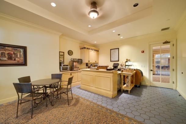 A cozy kitchen and dining area with a counter, appliances, and seating arrangement.