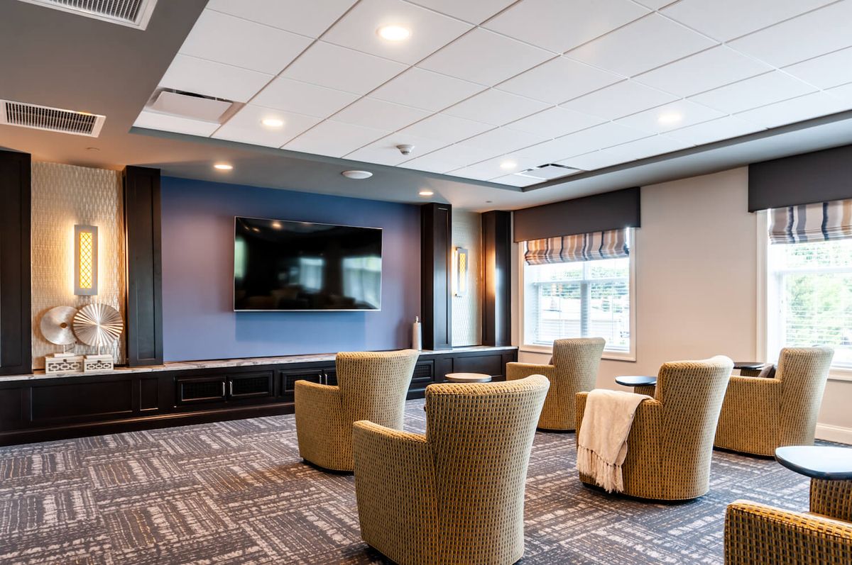 A modern living room with comfortable seating and a large television.