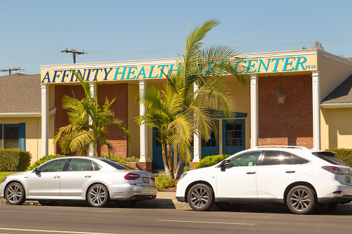 A view of Affinity Health Center showcasing its modern architecture and surrounding vehicles.