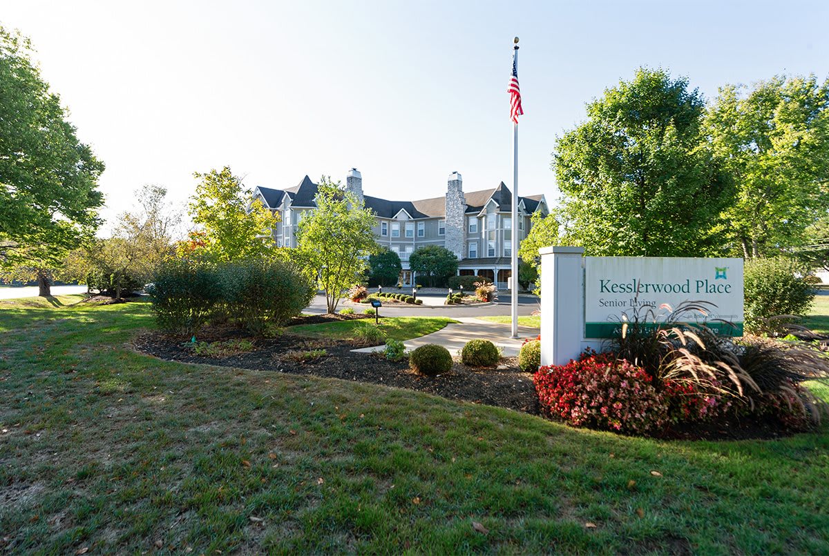 A scenic view of a building surrounded by landscaped gardens and trees.