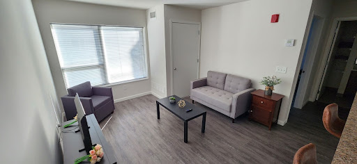 A cozy living room featuring modern furniture and ample natural light.