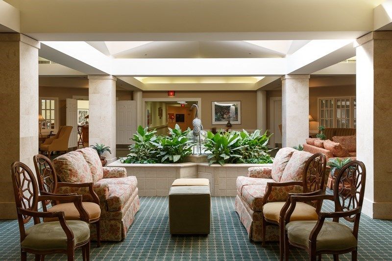 A well-lit lobby with comfortable seating and greenery.