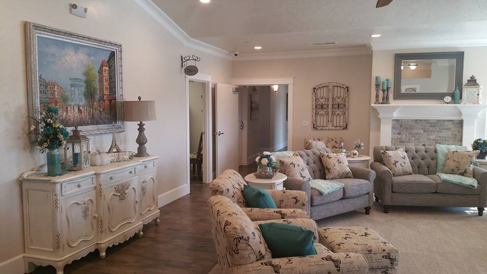A cozy living room with comfortable sofas, armchairs, and tasteful decor accents.