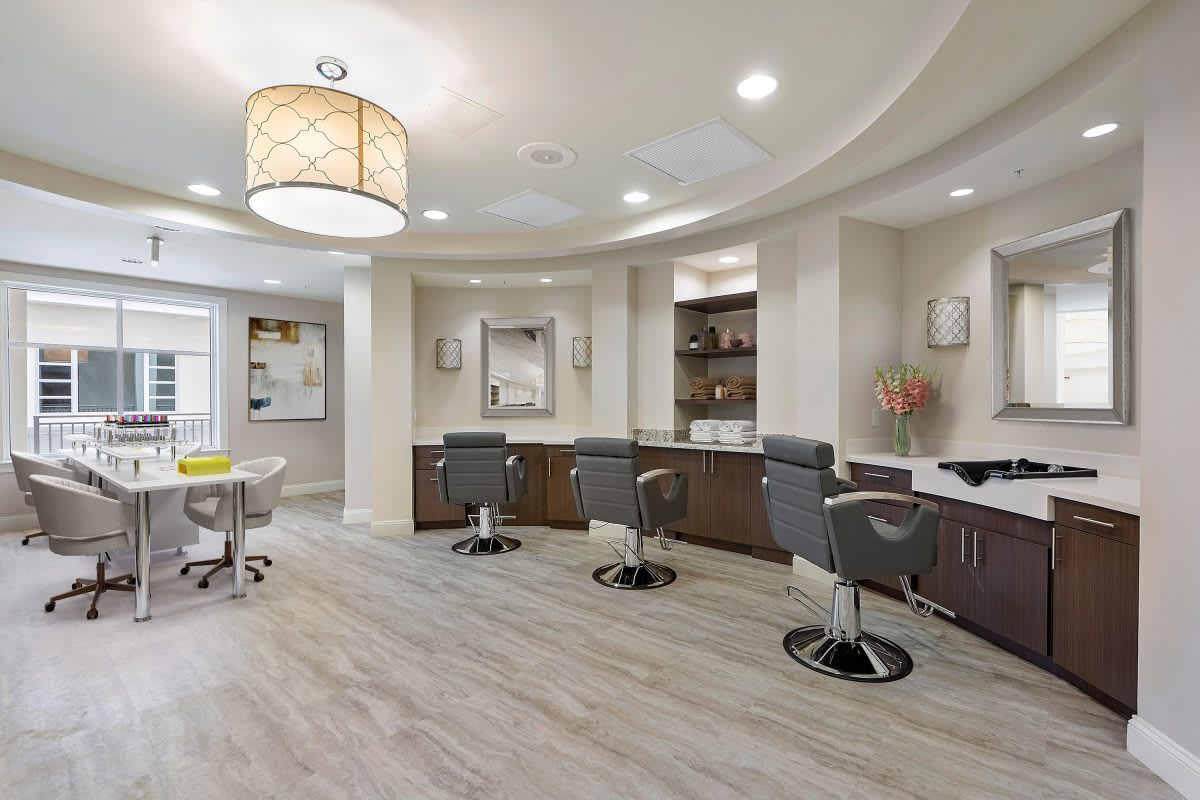 A modern salon interior with styling chairs and elegant decor.