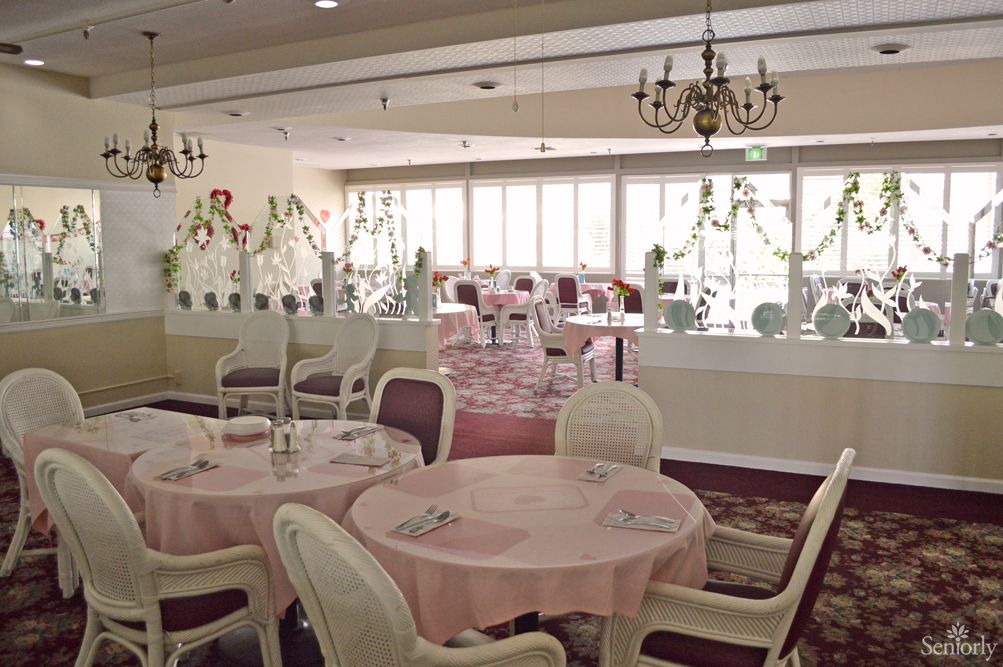 An elegant restaurant dining room with pastel colors and classic furnishings.