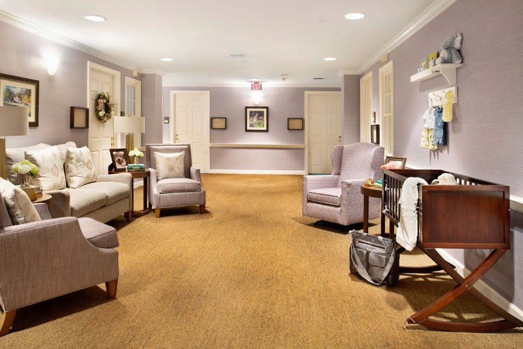 A cozy and well-decorated hallway with seating arrangements and soft lighting.