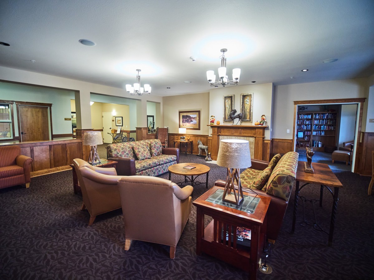 A cozy living room with comfortable seating and warm lighting.