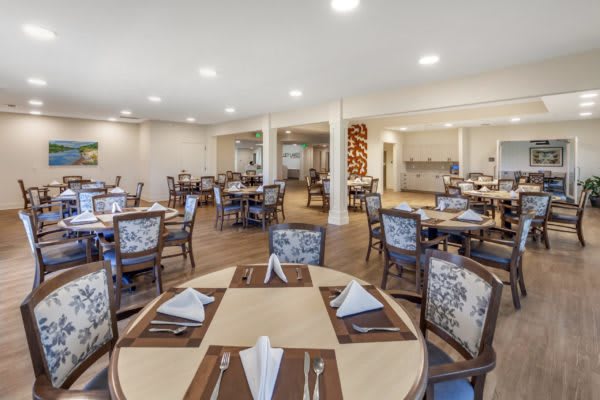 An elegant dining room setup with neatly arranged tables and chairs.