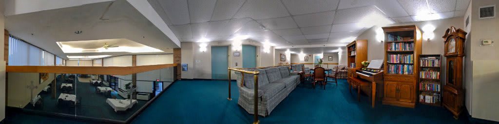 A hotel lobby area with seating and elevators.