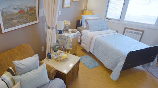 A cozy bedroom featuring soft bedding and warm decor.