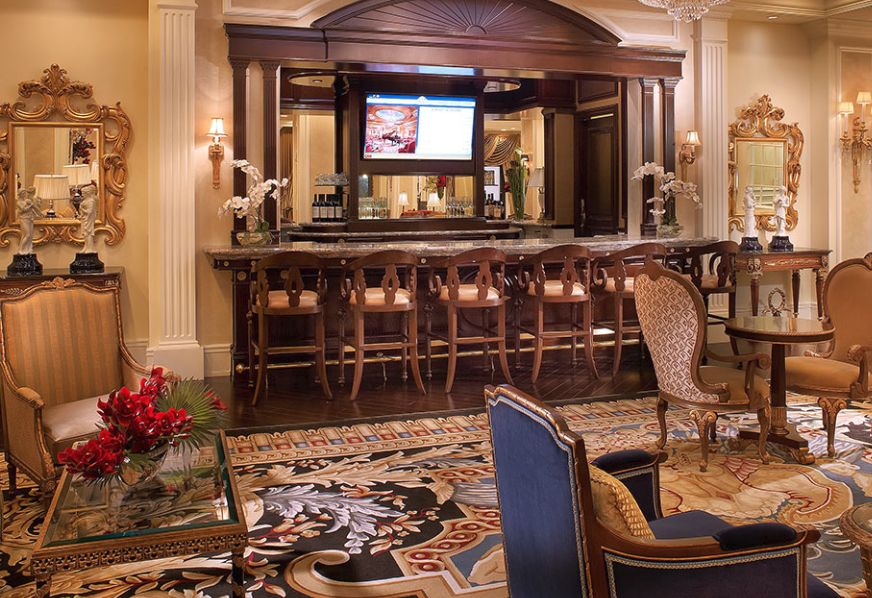 A luxurious hotel lobby bar with elegant seating and a sophisticated decor.