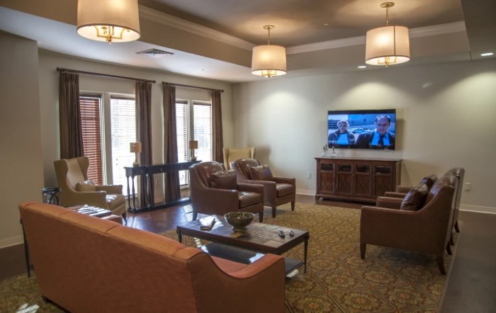 A cozy living room featuring modern furniture and a television.