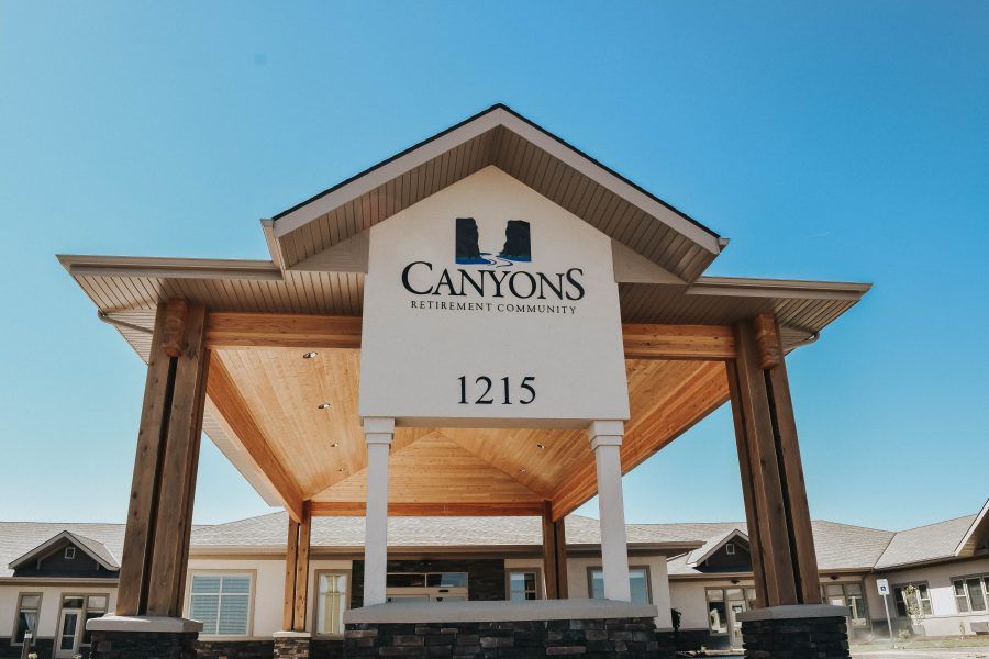 Entrance to Canyons Retirement Community with visible signage and address.