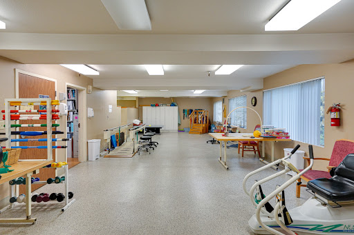 A spacious and well-lit rehabilitation room in a healthcare facility.