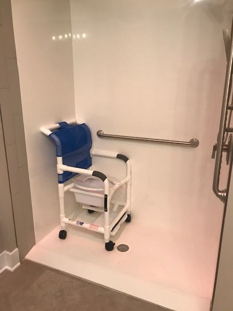 An accessible shower with a mobility wheelchair designed for ease of use.